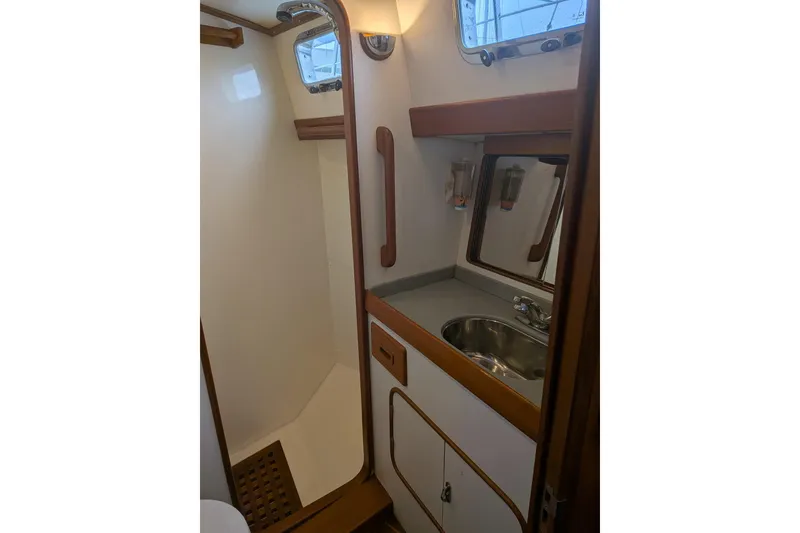 Slide: The Image of 1994 Passport Royal Passport 44 yacht kitchen with wooden cabinetry and modern appliances. - 15