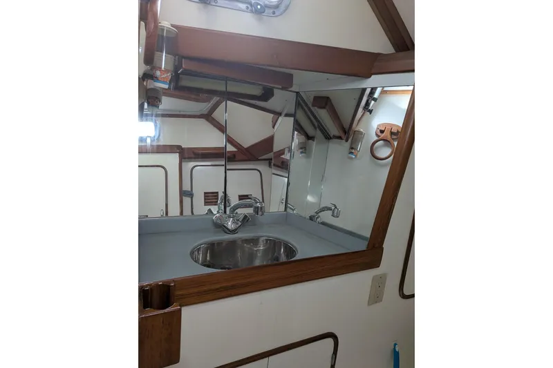 Slide: The Image of Navigation station of 1994 Passport Royal Passport 44 yacht with control panels and seating. - 17