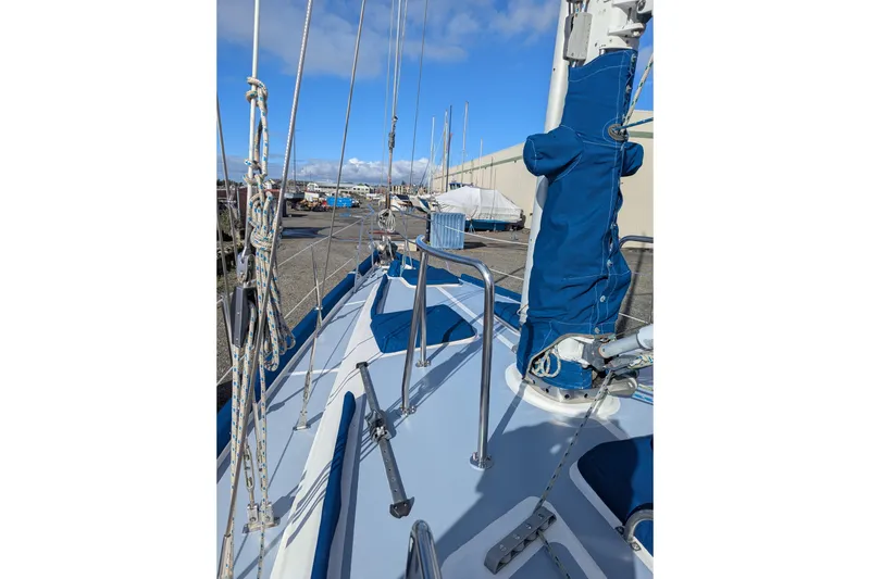 Slide: The Image of Sailboat silhouetted against a vibrant sunset over calm waters, Passport Royal Passport 44, 1994. - 2