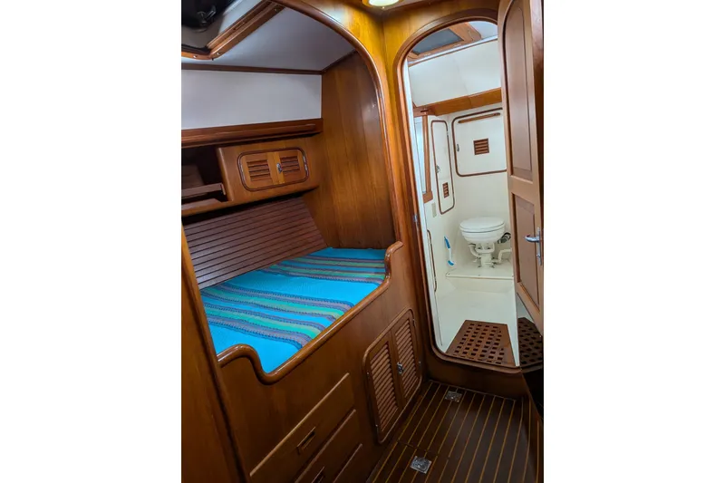 Slide: The Image of Cozy cabin interior of 1994 Passport Royal Passport 44 yacht with wooden finish and compact bathroom. - 26