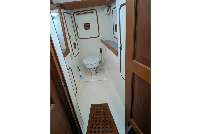 Slide: The Image of 1994 Passport Royal Passport 44 yacht bathroom with wooden accents and compact design. - 27