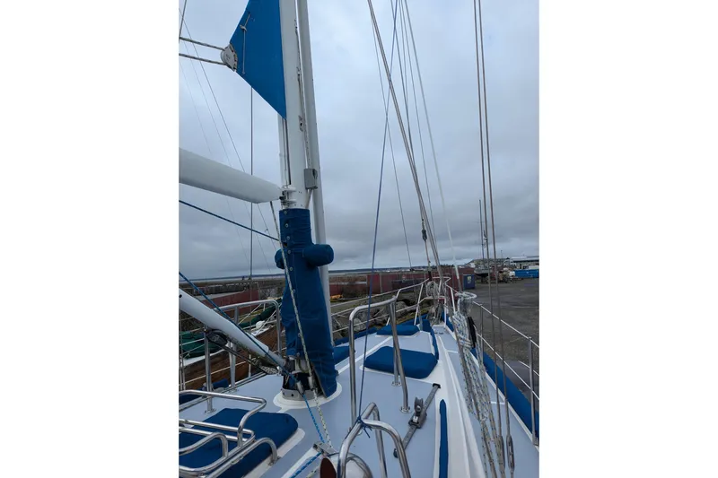 Slide: The Image of Sailboat deck view of 1994 Passport Royal Passport 44, featuring blue sail covers. - 3