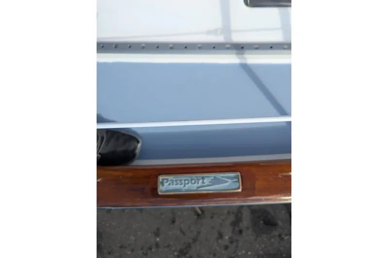 Slide: The Image of Deck view of 1994 Passport Royal Passport 44 sailboat, featuring sleek design and blue cover. - 5