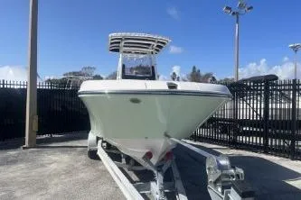 Slide: The Image of 2023 Trophy T24 CC boat on trailer, parked outdoors under clear blue sky. - 3