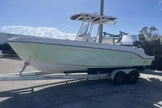 Slide: The Image of 2023 Trophy T24 CC boat on trailer under clear sky. - 5