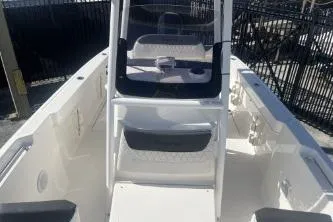 Slide: The Image of 2023 Trophy T24 CC boat interior with seating and console, docked outdoors. - 9