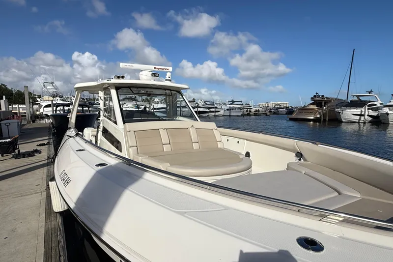 Slide: The Image of 2017 Boston Whaler 420 Outrage docked at marina under blue sky. - 10