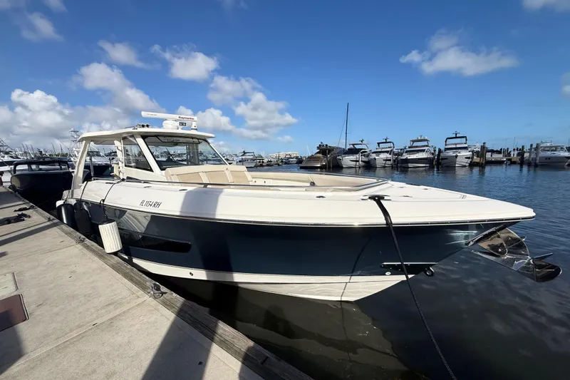 Slide: The Image of 2017 Boston Whaler 420 Outrage docked at marina under blue sky. - 11