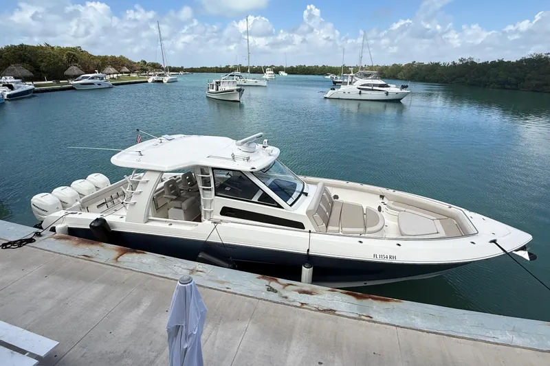 Slide: The Image of 2017 Boston Whaler 420 Outrage docked in a serene marina setting. - 17