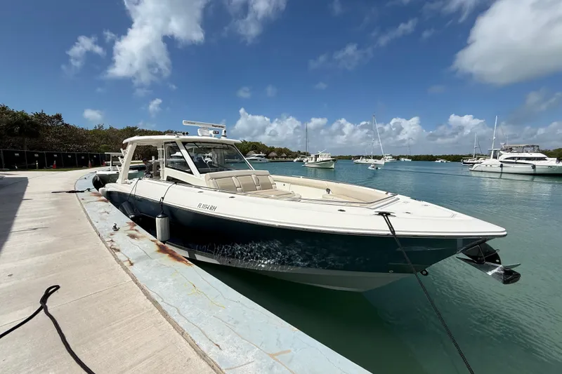 Slide: The Image of 2017 Boston Whaler 420 Outrage docked in a scenic marina under a blue sky. - 18