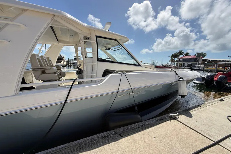Slide: The Image of 2017 Boston Whaler 420 Outrage docked under a sunny sky. - 22