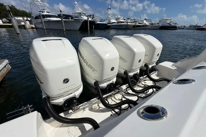 Slide: The Image of 2017 Boston Whaler 420 Outrage with four Mercury outboard engines docked at marina. - 23