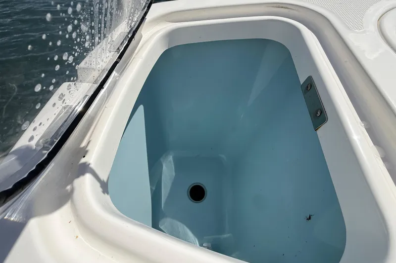 Slide: The Image of Livewell on 2017 Boston Whaler 420 Outrage boat, featuring clean interior and water droplets. - 24