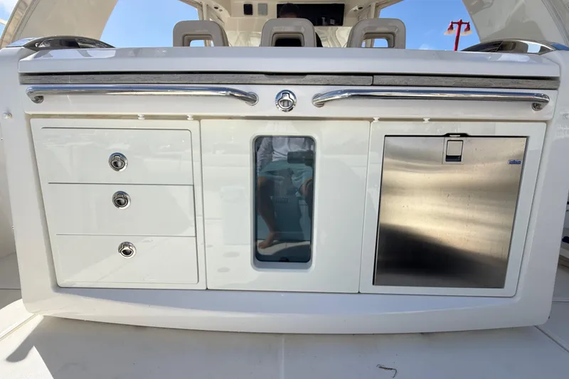 Slide: The Image of 2017 Boston Whaler 420 Outrage boat interior with storage compartments and stainless steel features. - 25