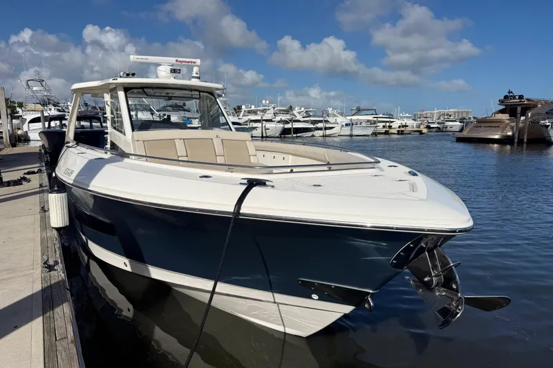 Slide: The Image of 2017 Boston Whaler 420 Outrage docked at marina under blue sky. - 3