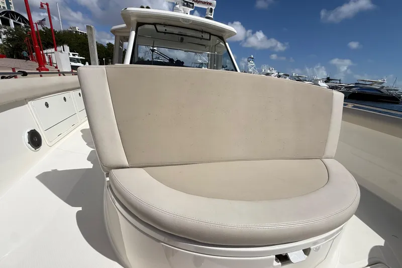 Slide: The Image of 2017 Boston Whaler 420 Outrage boat with beige seating, docked under a clear blue sky. - 31