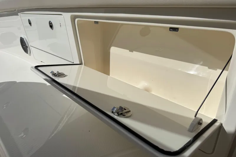 Slide: The Image of 2017 Boston Whaler 420 Outrage storage compartment with open hatch and secure latches. - 33