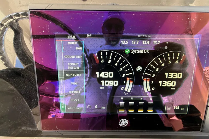 Slide: The Image of Dashboard display of a 2017 Boston Whaler 420 Outrage boat showing engine metrics. - 42