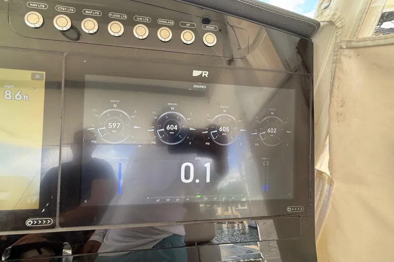 Slide: The Image of Dashboard of a 2017 Boston Whaler 420 Outrage showing engine data and depth. - 43