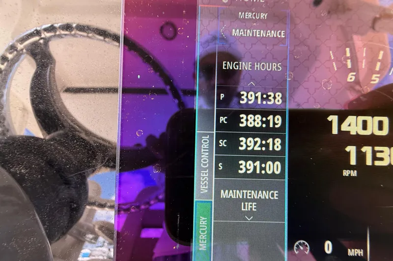 Slide: The Image of 2017 Boston Whaler 420 Outrage dashboard showing engine hours and RPM display. - 47