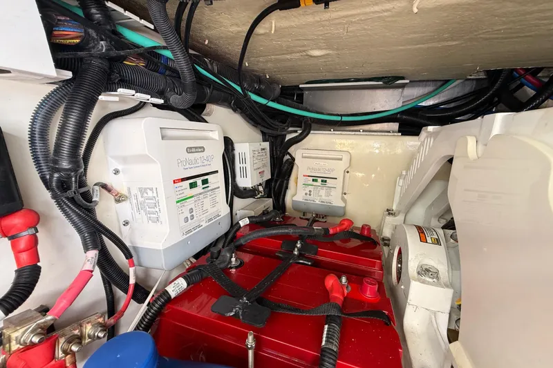 Slide: The Image of Engine compartment of a 2017 Boston Whaler 420 Outrage with electrical components and wiring. - 50