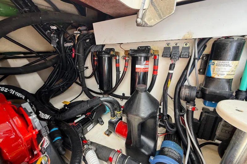 Slide: The Image of Engine compartment of a 2017 Boston Whaler 420 Outrage with various mechanical components. - 52