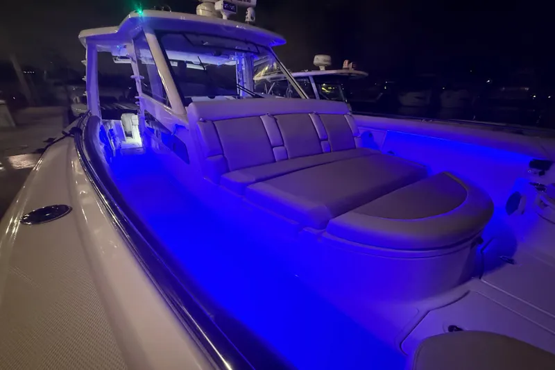 Slide: The Image of 2017 Boston Whaler 420 Outrage boat with blue LED lighting at night. - 6