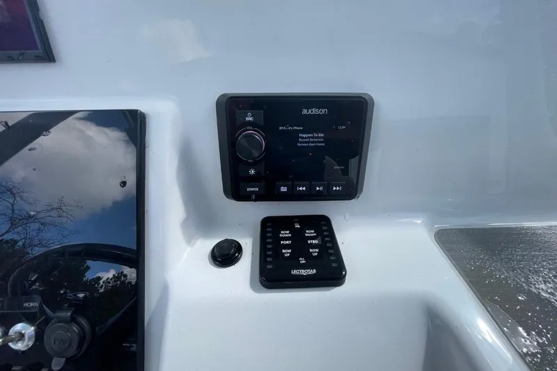 Slide: The Image of 2023 Sea Pro 248 Bay boat dashboard with Audison audio system and Lectrotab controls. - 11