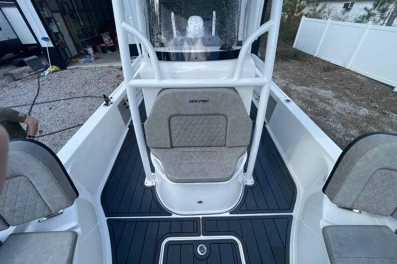 Slide: The Image of 2023 Sea Pro 248 Bay boat interior with gray seating and black flooring. - 15