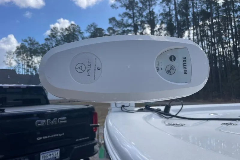 Slide: The Image of 2023 Sea Pro 248 Bay boat with i-Pilot Riptide trolling motor, parked near a GMC truck. - 17