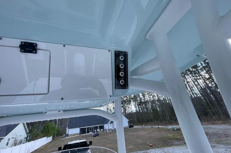 Slide: The Image of 2023 Sea Pro 248 Bay boat interior with control panel, outdoor setting. - 18