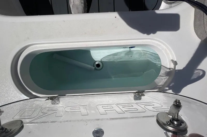 Slide: The Image of 2023 Sea Pro 248 Bay livewell with clear lid and water inside. - 25