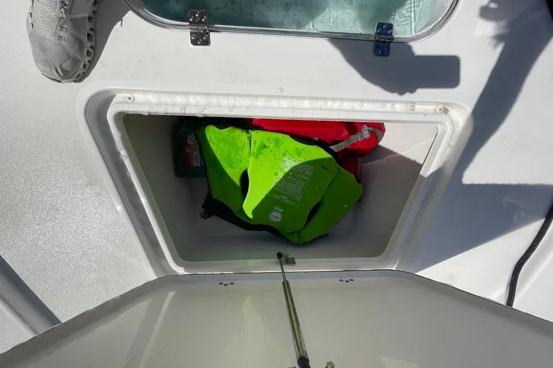 Slide: The Image of Storage compartment on 2023 Sea Pro 248 Bay boat with life jackets inside. - 26