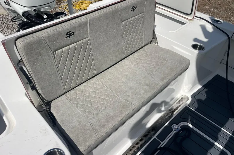 Slide: The Image of 2023 Sea Pro 248 Bay boat seat with diamond-pattern upholstery and cup holder. - 28