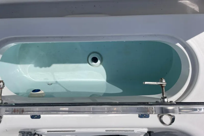 Slide: The Image of 2023 Sea Pro 248 Bay boat livewell with open lid and water inside. - 30