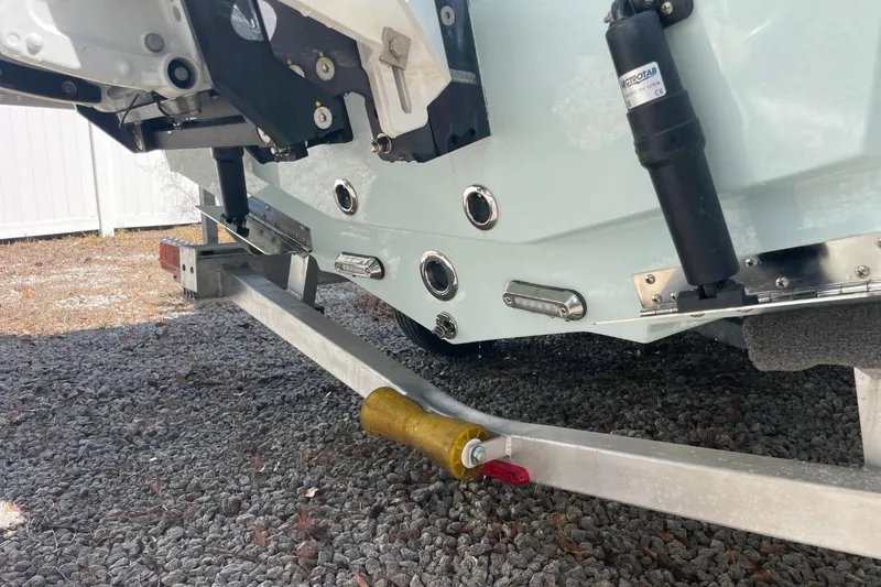 Slide: The Image of 2023 Sea Pro 248 Bay boat on trailer, showing rear hull and trim tabs. - 34