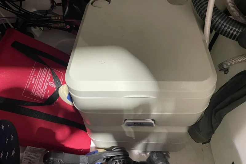 Slide: The Image of Portable toilet in a 2023 Sea Pro 248 Bay boat storage area. - 37
