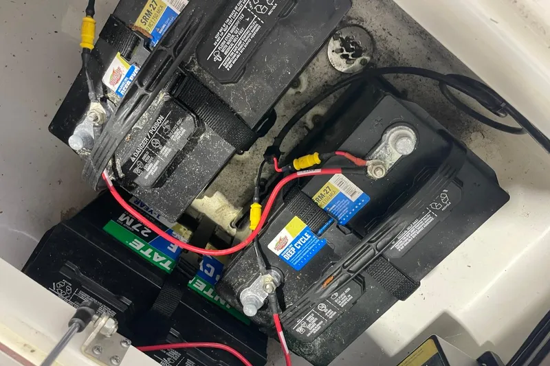 Slide: The Image of Batteries installed in a 2023 Sea Pro 248 Bay boat, showcasing wiring and connections. - 38