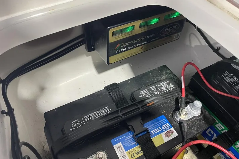 Slide: The Image of Battery compartment of 2023 Sea Pro 248 Bay boat with charger and wiring. - 39