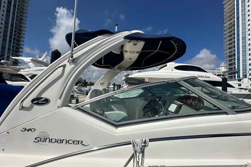 Slide: The Image of 2008 Sea Ray 340 Sundancer yacht docked, showcasing sleek design and modern features. - 11