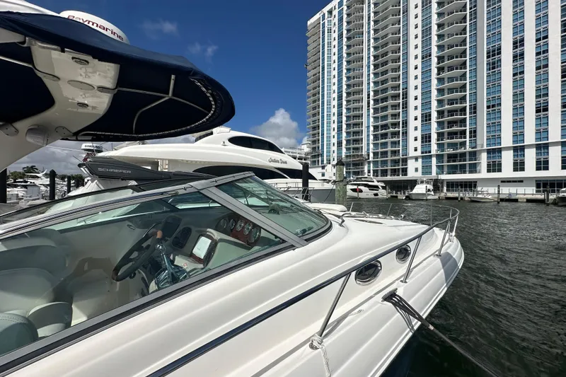 Slide: The Image of 2008 Sea Ray 340 Sundancer docked near modern high-rise buildings. - 12