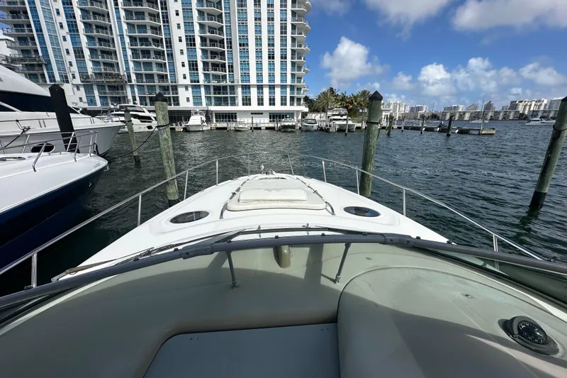 Slide: The Image of 2008 Sea Ray 340 Sundancer docked near waterfront buildings under blue sky. - 13