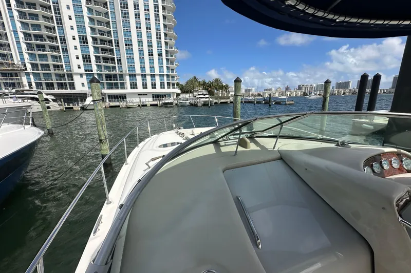 Slide: The Image of 2008 Sea Ray 340 Sundancer yacht docked near waterfront high-rise buildings. - 14