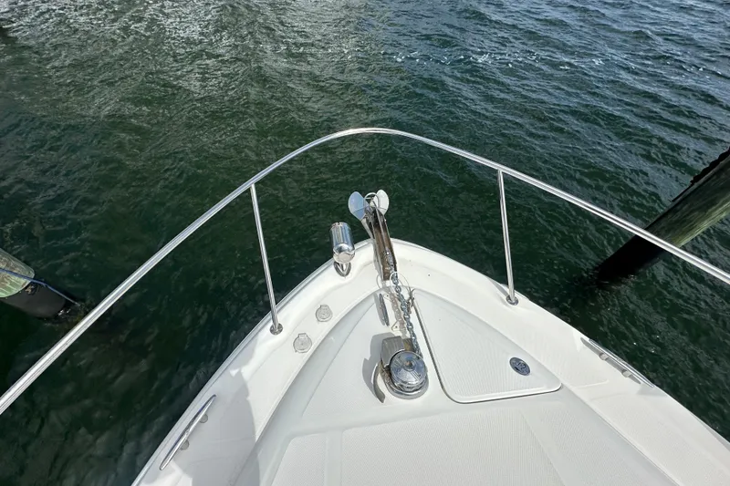 Slide: The Image of Bow view of 2008 Sea Ray 340 Sundancer on water, showcasing anchor and railing. - 15