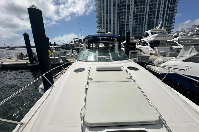 Slide: The Image of 2008 Sea Ray 340 Sundancer docked at marina, surrounded by other boats and high-rise buildings. - 18