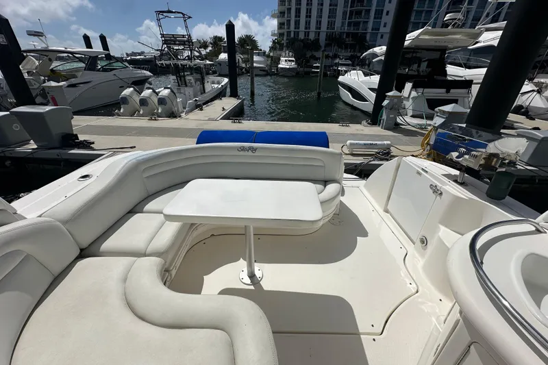 Slide: The Image of 2008 Sea Ray 340 Sundancer yacht interior with white seating and table at marina. - 22