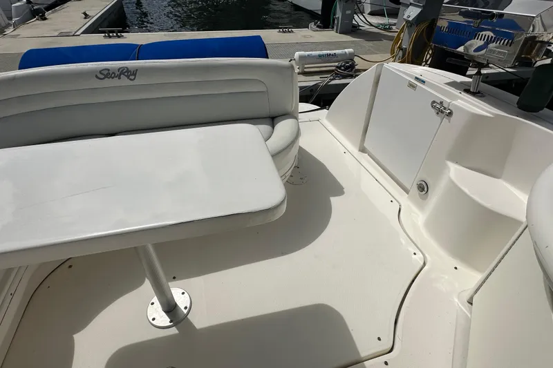 Slide: The Image of 2008 Sea Ray 340 Sundancer boat interior with seating and table at dock. - 24