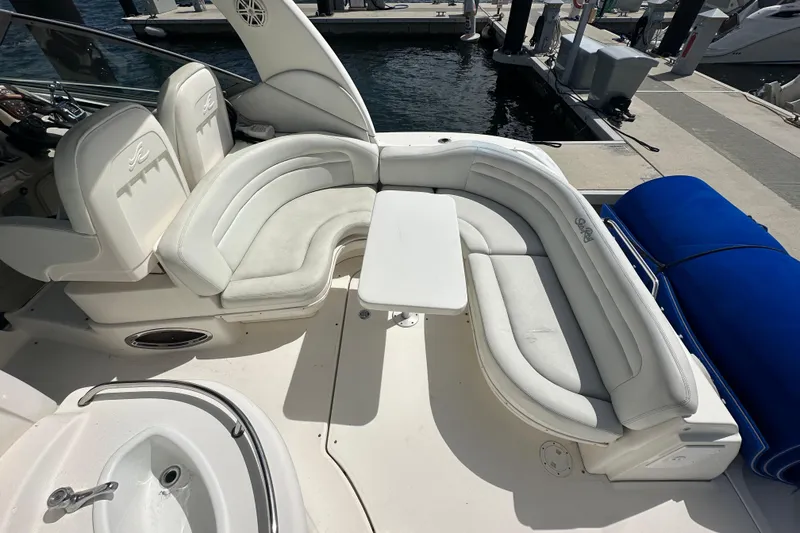 Slide: The Image of 2008 Sea Ray 340 Sundancer boat interior with white seating and table at marina. - 25