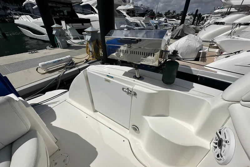 Slide: The Image of 2008 Sea Ray 340 Sundancer with onboard grill at marina, surrounded by yachts. - 28