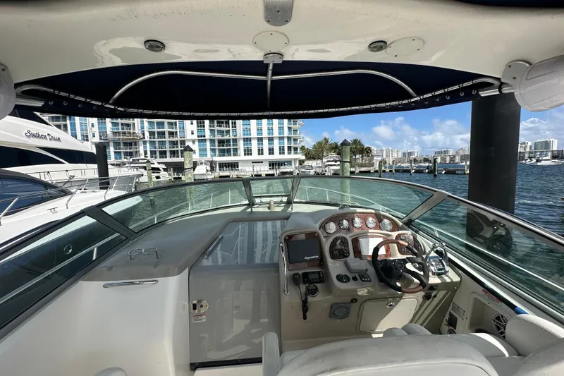 Slide: The Image of 2008 Sea Ray 340 Sundancer helm with marina view, featuring modern controls and navigation. - 29